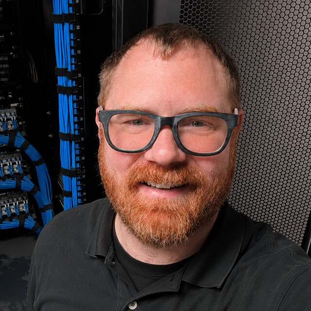 Tyler in front of a network rack